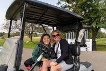 Sue and Willow Jacques in a golf cart at the 2020 Hickory Dickory Decks Charity Golf Tournament.